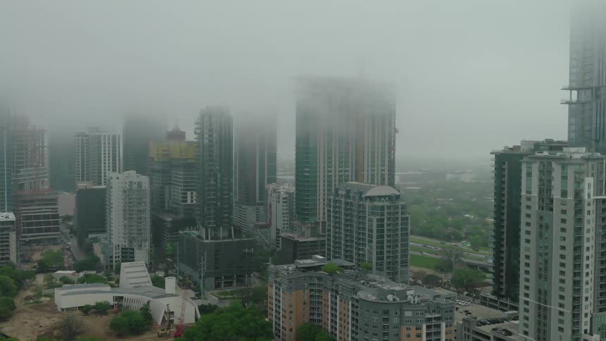 Panorama of a metropolis with skyscrapers on a foggy day
