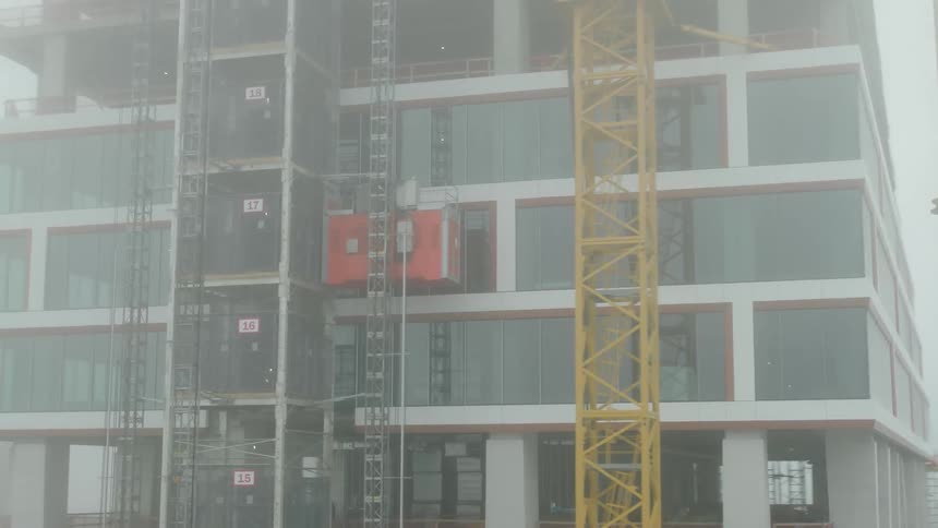 Aerial view of a skyscraper under construction seen during fog