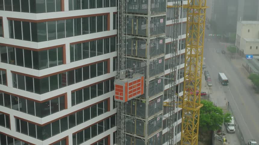 Construction site with a partially completed building and an adjacent crane