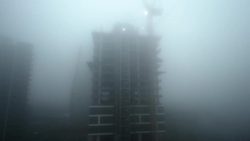 Aerial view of a building under construction seen during fog
