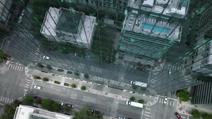 Top view of the exterior architecture of a modern mirrored skyscraper