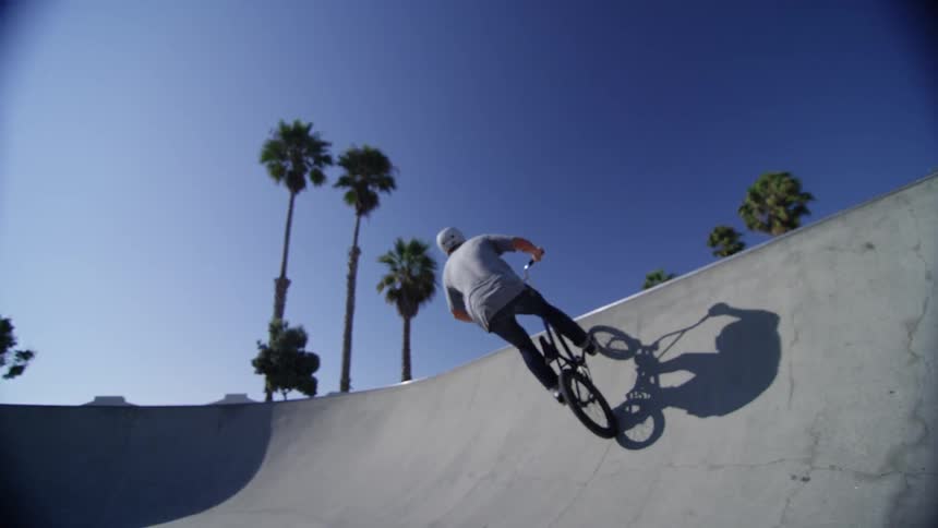 A bicyclist rides in a skate park