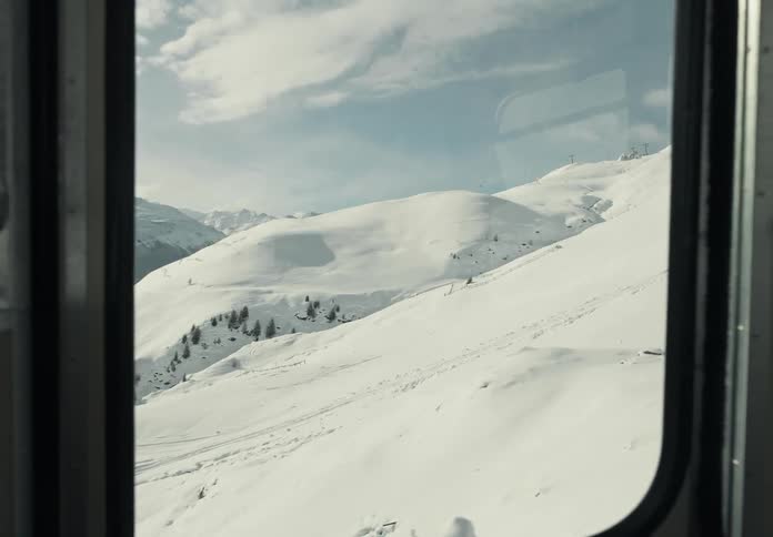Stunning view of snowcapped mountains captured through a cable car window