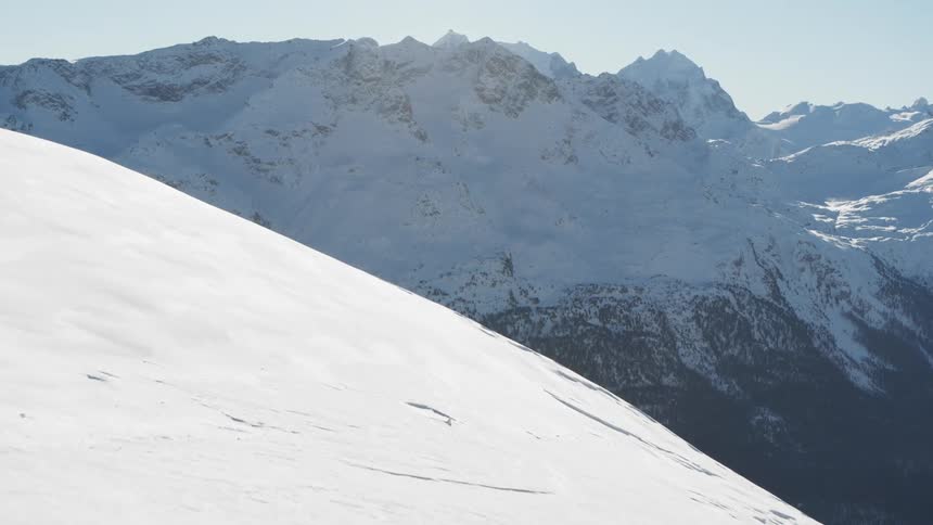 Ski slope with a mountain cliff in the background