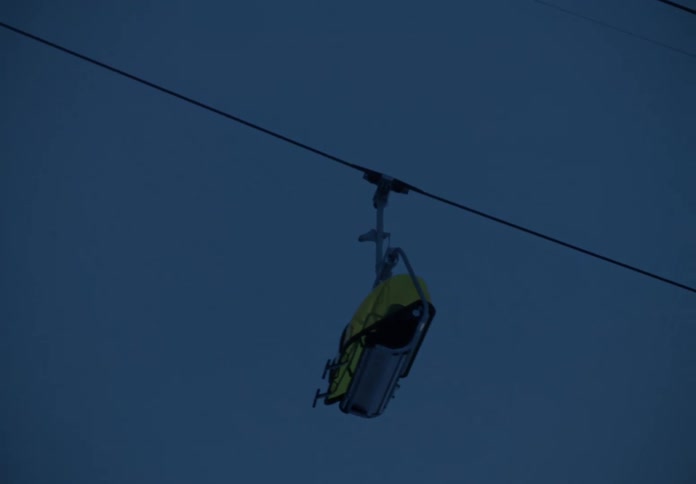 Cable cars moving up a mountain at dusk