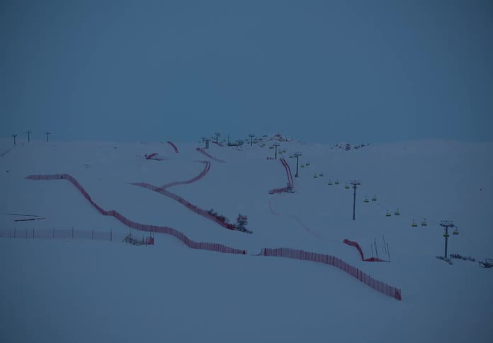 Landscape of a snowy mountain with ski lifts and a snowboard slope