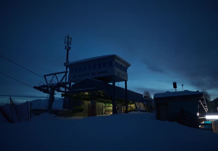 Cable car shed on a snowy mountain at night