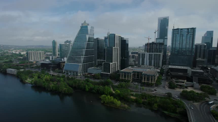 Aerial view of a tower block with one of the buildings curved in front