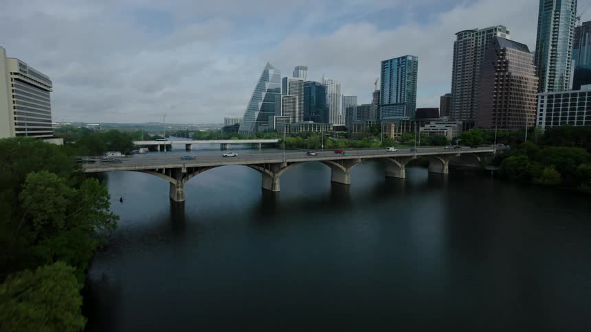 Urban landscape with modern buildings a bridge over a river and lots of vegetation around