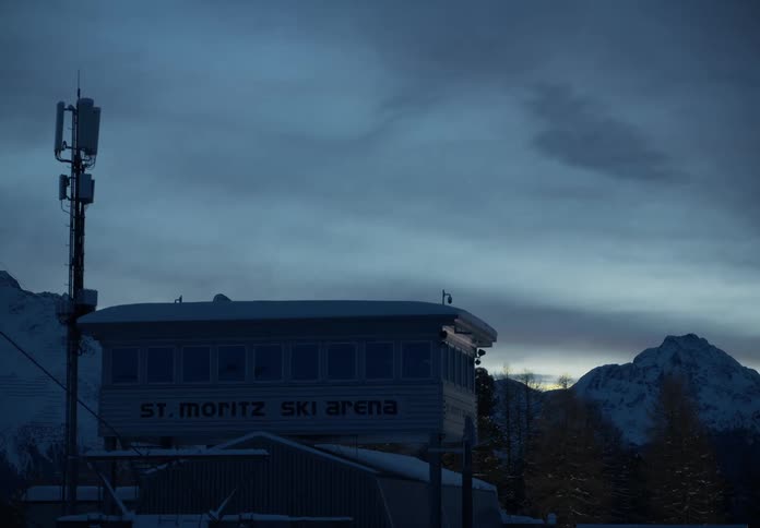 Building with the inscription ski arena and a cable car passing in the background