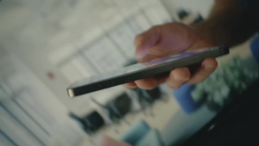 Hand holding and interacting with an iphone