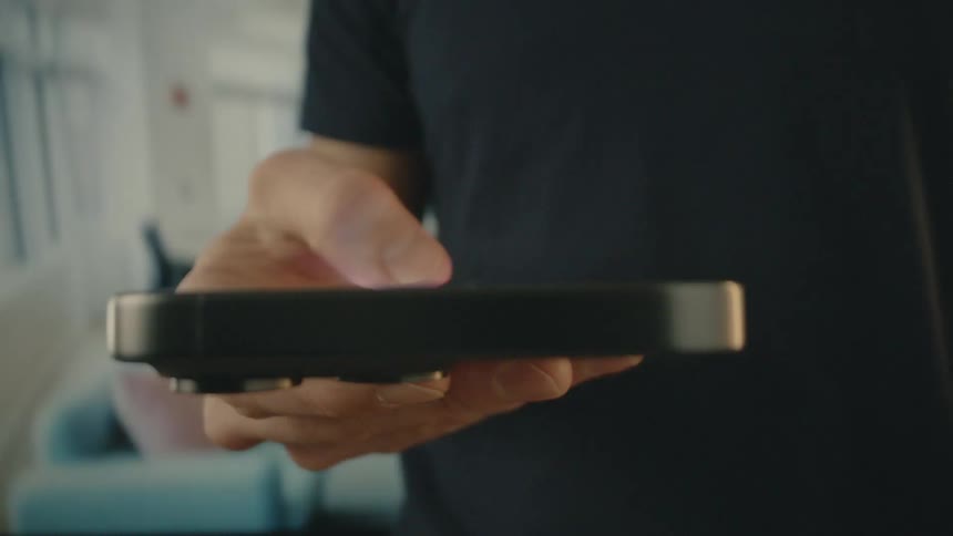 A footage of a man pressing a smartphone