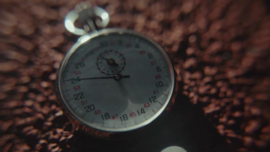 A ticking stopwatch is laying in the dirt