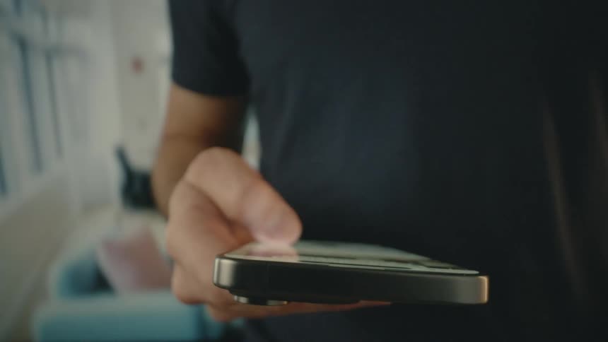 A man moves his phone screen using his thumb