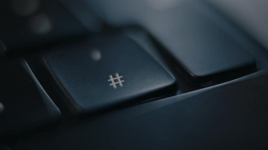 Person touches the hash key on a computer keyboard