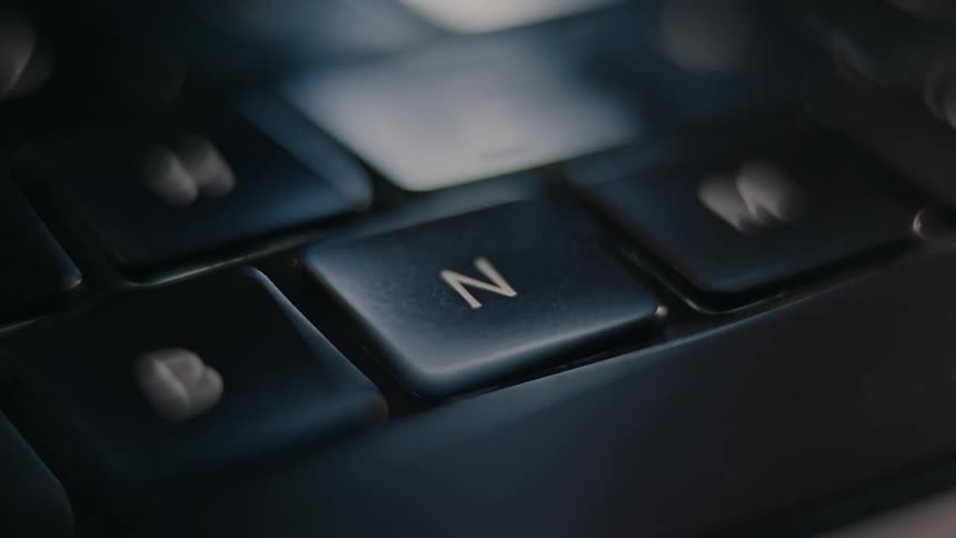 A person repeatedly presses keys on a computer keyboard