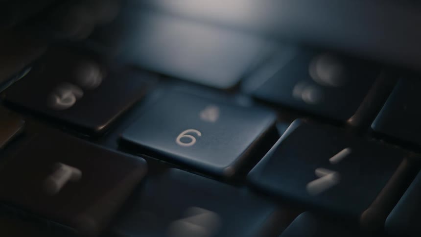 Persons finger clicking a laptop key