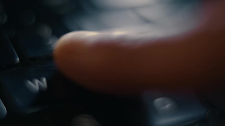 Index finger clicking a laptop key