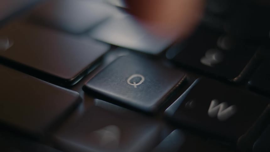 Fingers typing on a laptop