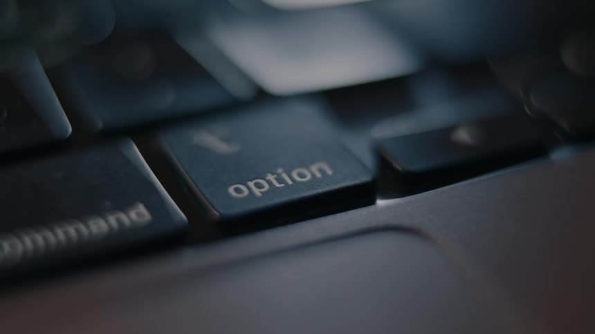 A close up of a finger pressing a key on a keyboard