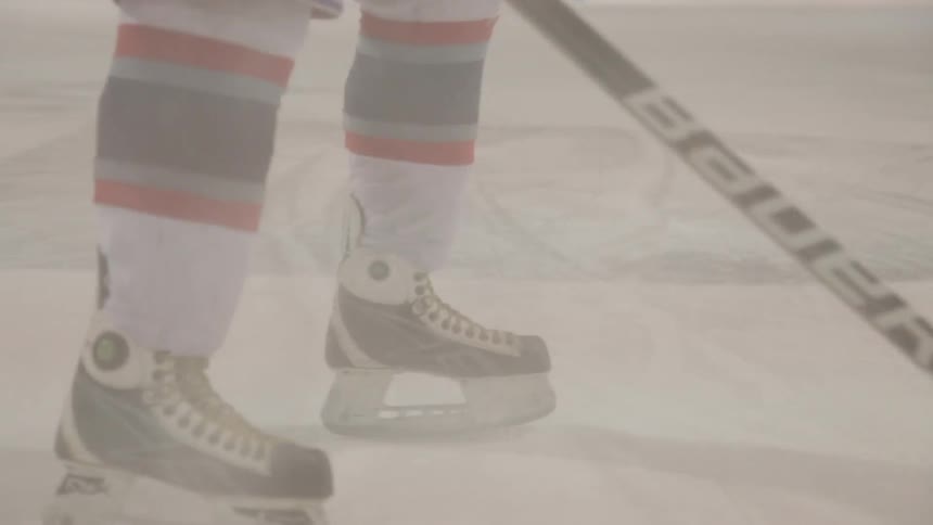 Hockey player slides in showing his skates