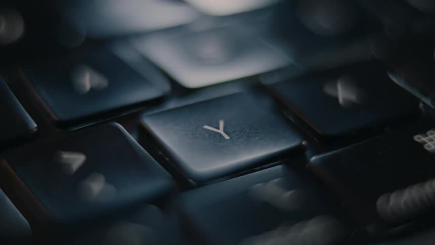 Fingers clicking keys on a laptop