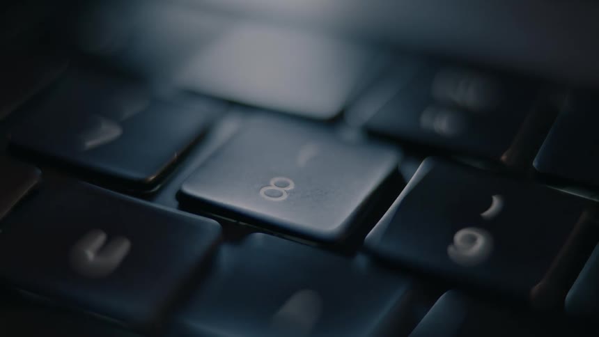 Finger pressing a laptop key