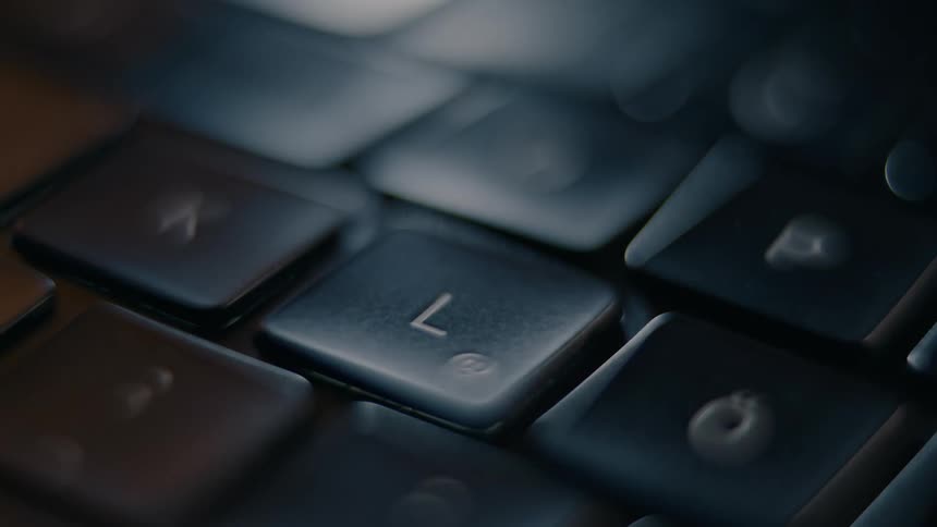 A close up of a finger pressing a key in a keyboard