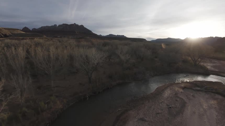The sun is rise over a river in the mountains