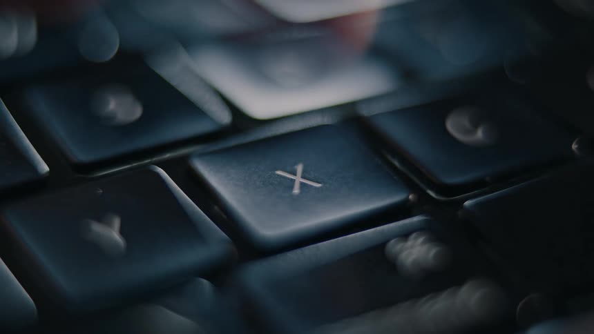 Fingers typing on a laptop