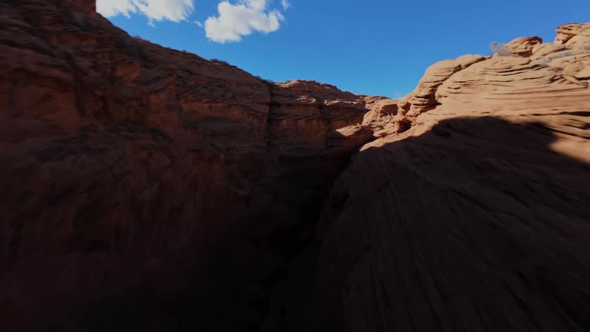 Twisting canyon leads to a bridge under a cloudy sky