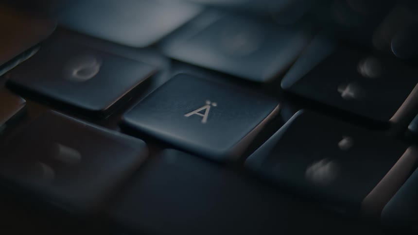 A person presses a key on the keyboard