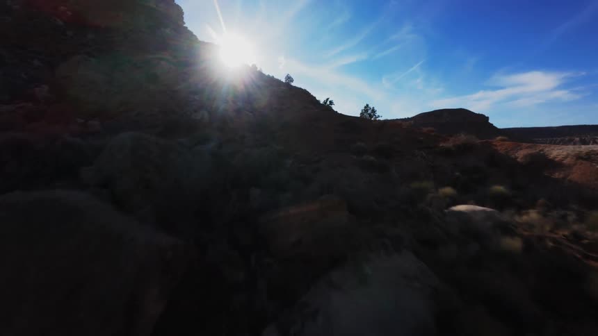Landscape of canyons and rocks in a natural environment with the reflection of the sun on the horizon