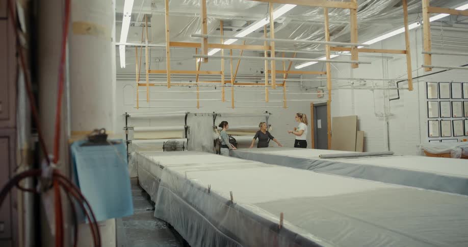 A clip of people discussing in a factory