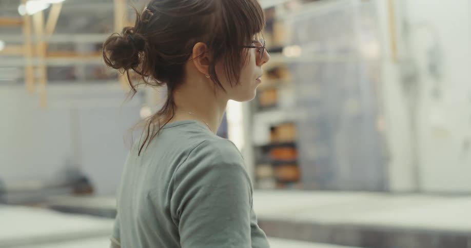 Woman indoors focused and wearing glasses