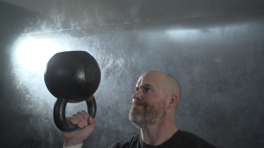 Man swinging kettlebell