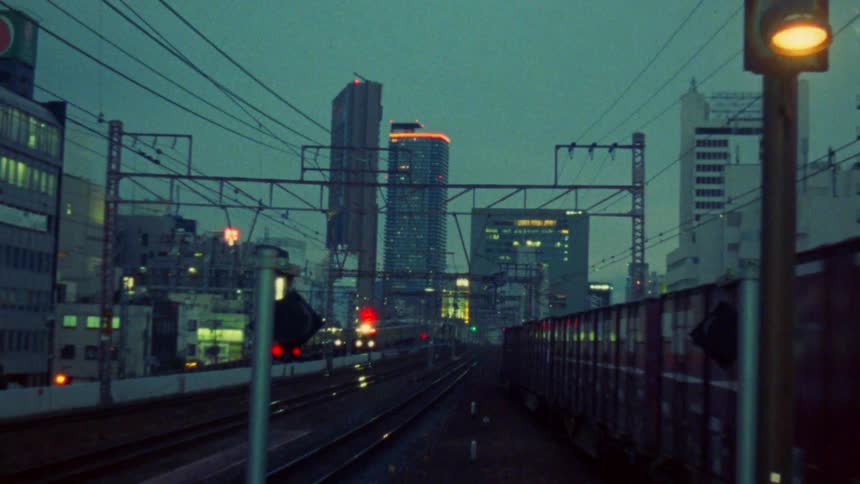 Trains moving along the tracks and a metropolis in the background