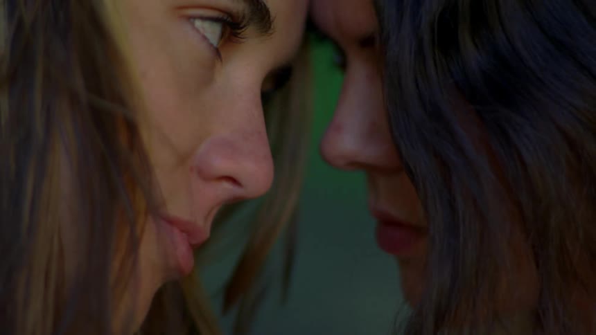 Closeup of two women resting their heads on each other touching their foreheads