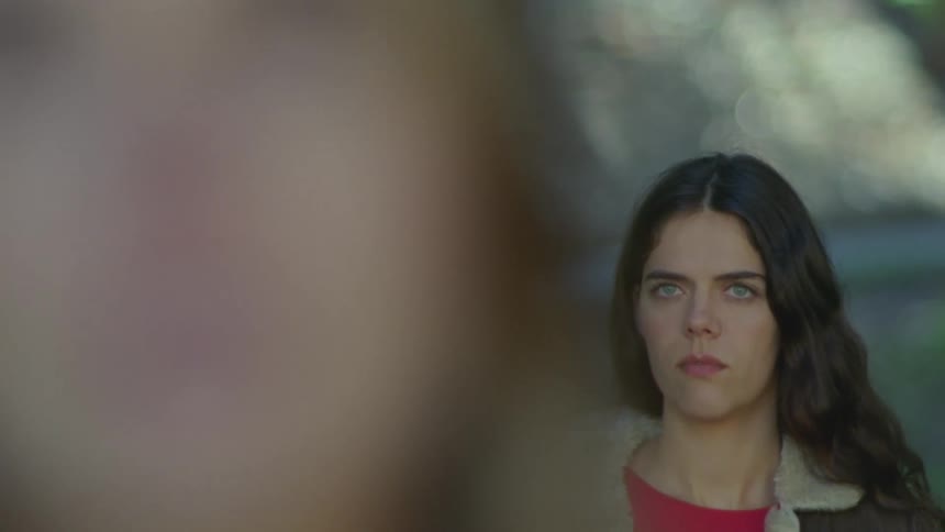 Closeup of the faces of two women standing one behind the other