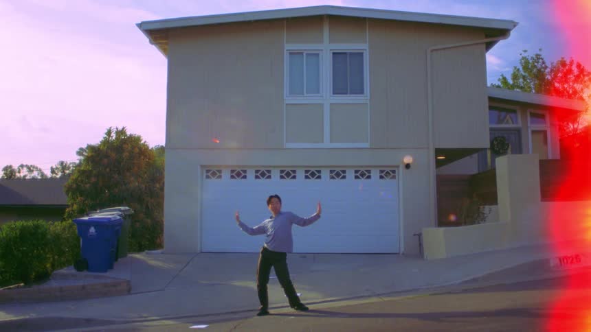 A man is dancing in front of the home