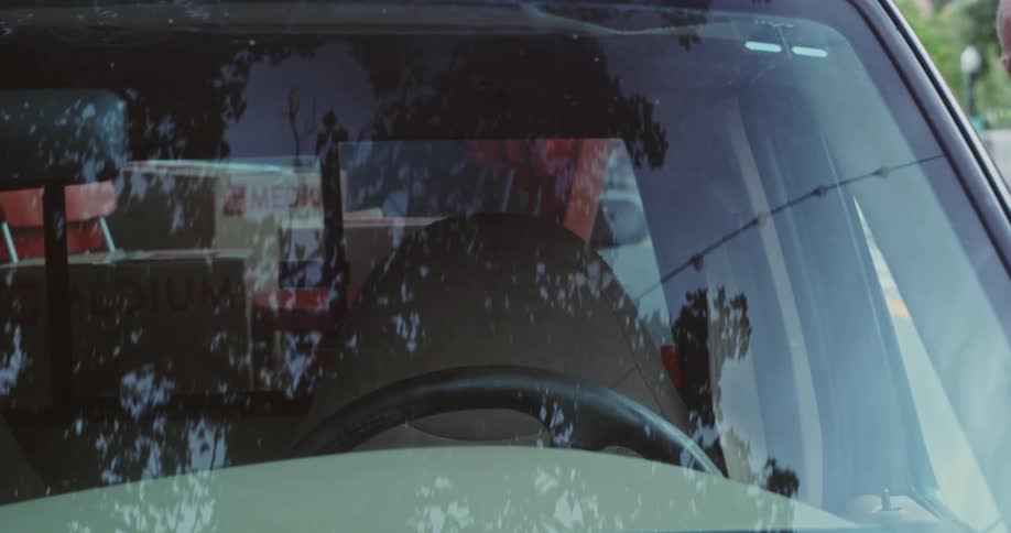Elderly man getting into a car