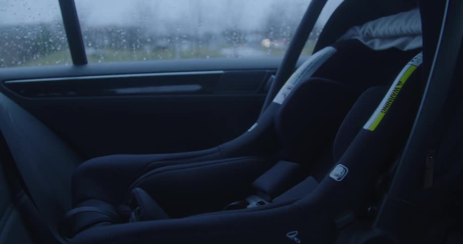Baby seat in a moving vehicle on a rainy day