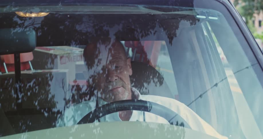 A man gets in his vehicle and prepares to drive away