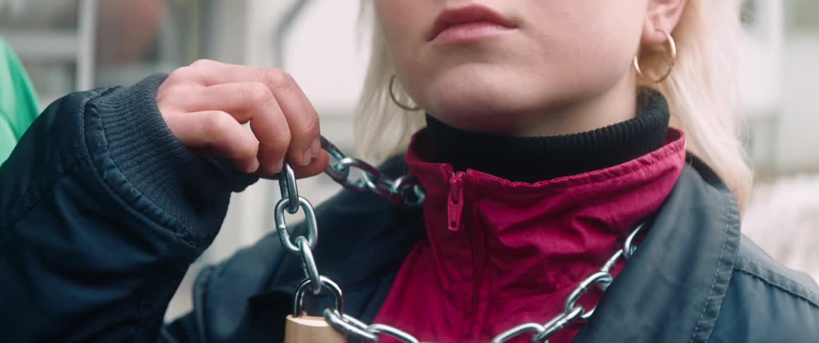 Woman wearing a chain necklace with padlock