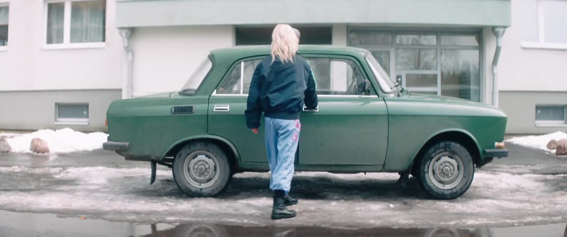Two women walk over and enter the car