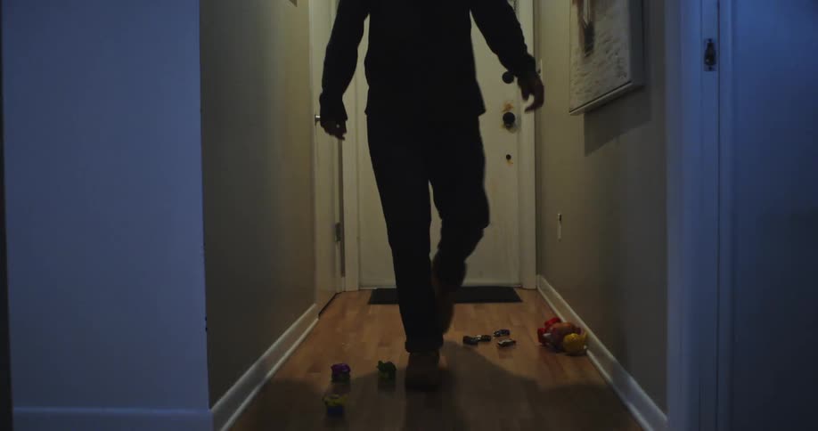 Man enters a home and walks to the bathroom to access a bottom cabinet