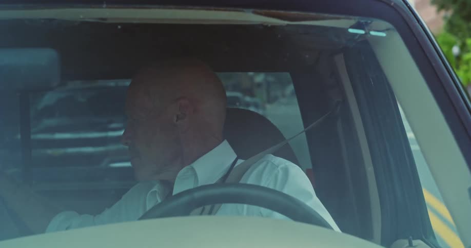 A man backs up into a parking spot