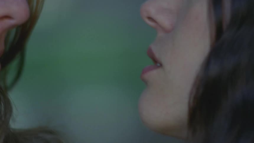 Portrait of two women hugging and looking at each other