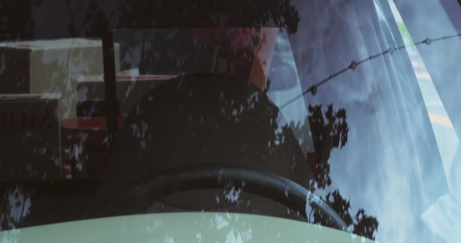 Man putting boxes into a pickup truck and getting into the car