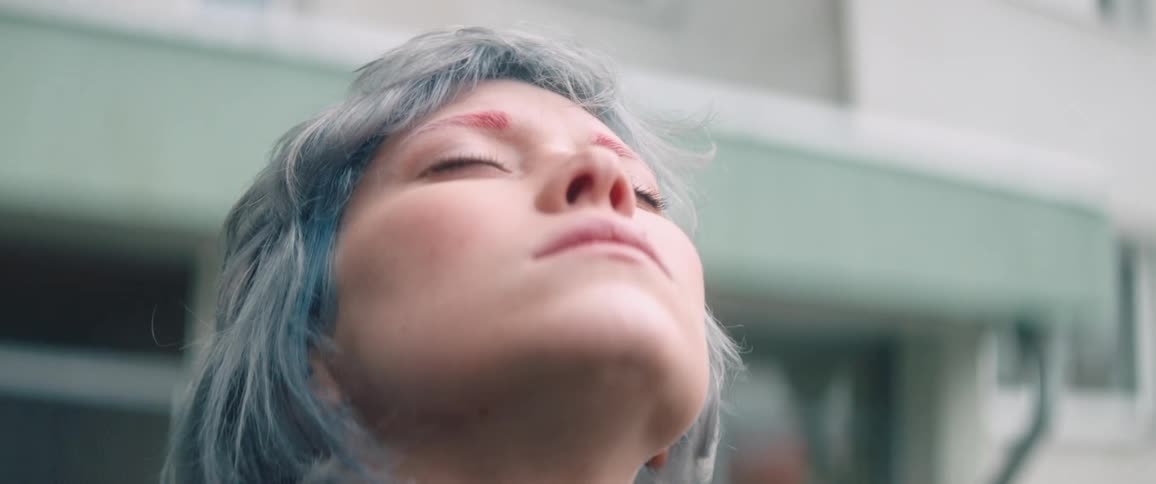 A woman is looking up at the sky